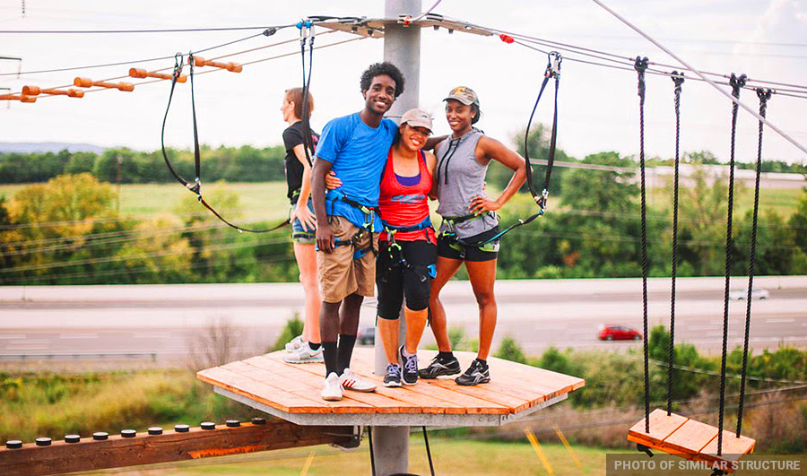people posing on ropes course platform